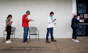 People who lost their jobs wait in line to file for unemployment following an outbreak of the coronavirus disease (COVID-19), at an Arkansas Workforce Center in Fayetteville, Arkansas, U.S. April 6, 2020. REUTERS/Nick Oxford