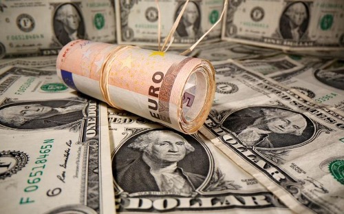 Rolled Euro banknotes are placed on U.S. Dollar banknotes in this illustration taken May 26, 2020. REUTERS/Dado Ruvic/Illustration