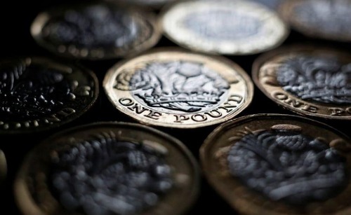 FILE PHOTO: Pound coins are seen in this photo illustration taken in Manchester, Britain September 6, 2017. REUTERS/Phil Noble/File Photo