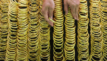 Gold Gains over 1% as USD, Yields Ease; Spotlight on Trade