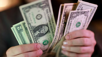 Dollar Edges Lower Before Expected Fed Hike